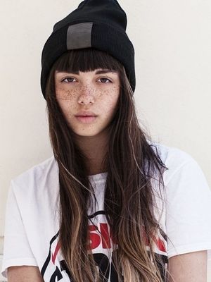 a girl with freckled hair and a beanie