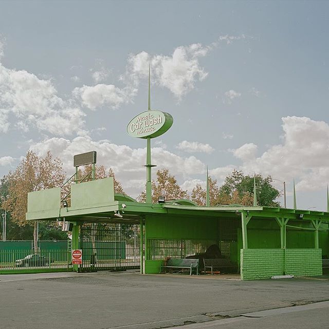 a green building with a clock on top of it