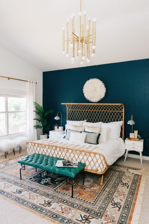 a bedroom with blue walls and a gold bed