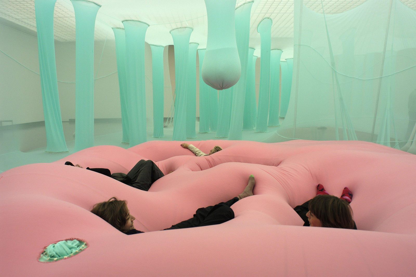 a woman laying on a pink inflatable bed