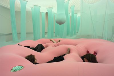 a woman laying on a pink inflatable bed