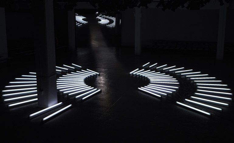 a black and white photo of a circular light sculpture