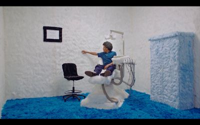 a man sitting on a chair in a room