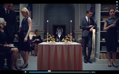 a group of people standing around a table with candles