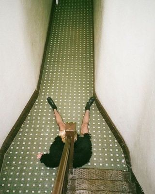 a woman falling down a flight of stairs