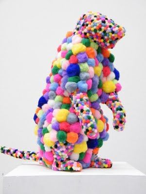 a sculpture of a colorful animal on a white pedestal