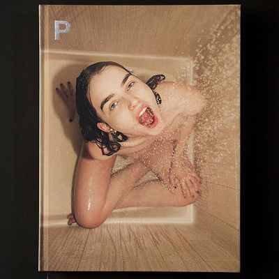 a young woman is taking a bath in a tub