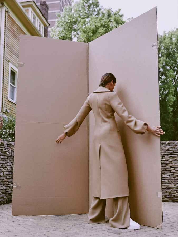 a woman standing in front of a large box