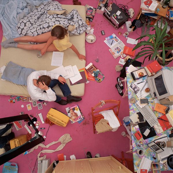 a couple of people laying on a bed in a room