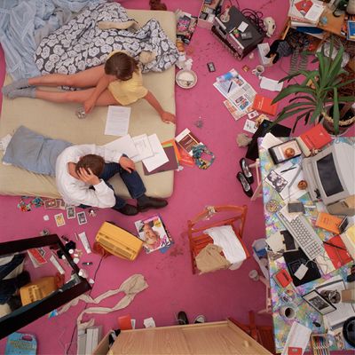 a couple of people laying on a bed in a room