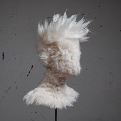 a stuffed animal with white fur on a stand