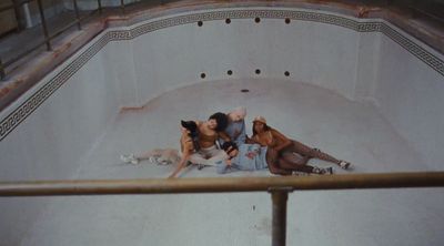 a group of women sitting on the floor of a bathtub