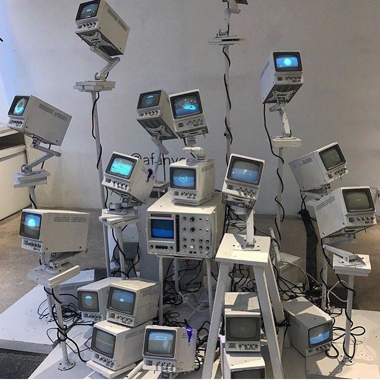 a bunch of old tvs sitting on top of each other