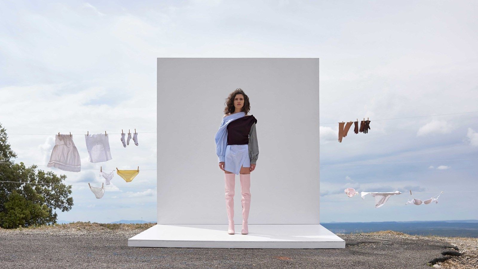 a woman standing in front of a display of clothes