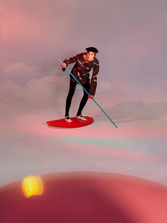 a man riding a surfboard on top of a wave