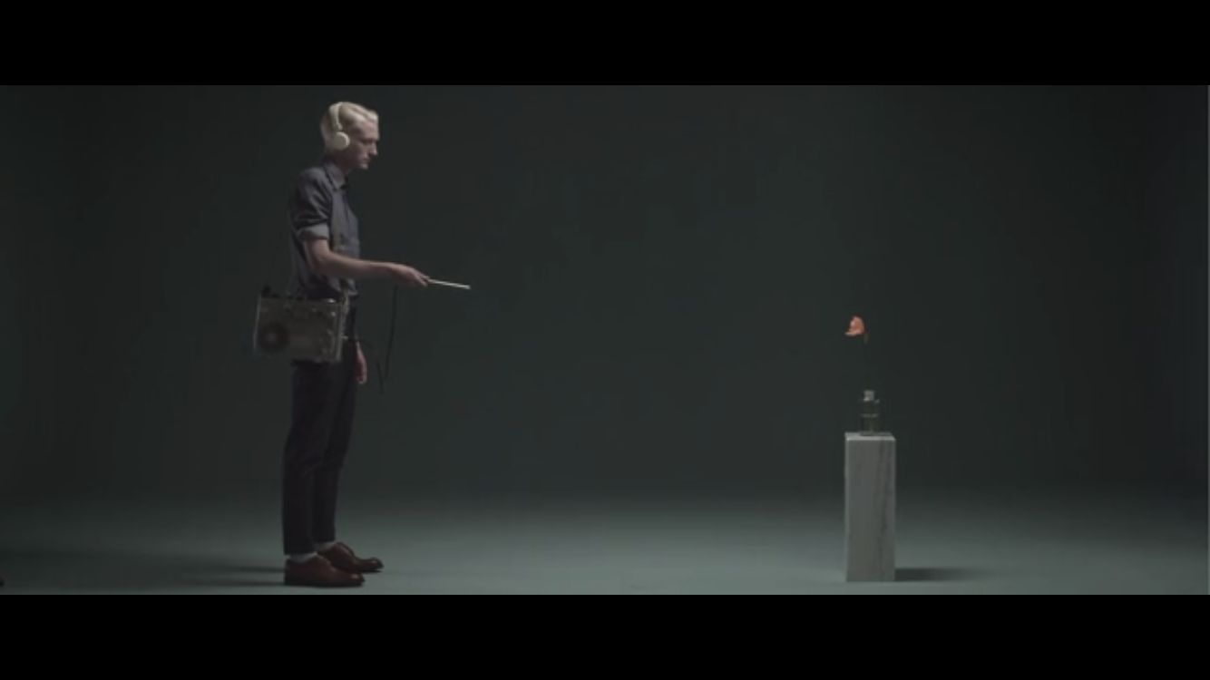 a man standing in front of a white box