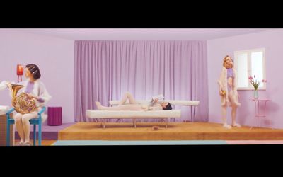 a couple of women sitting on top of a bed in a room