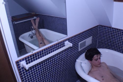 a man in a bathtub in a bathroom