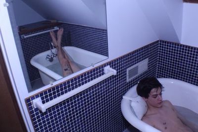a man in a bathtub in a bathroom