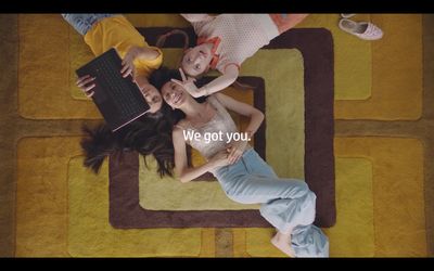 a group of young women laying on top of a rug