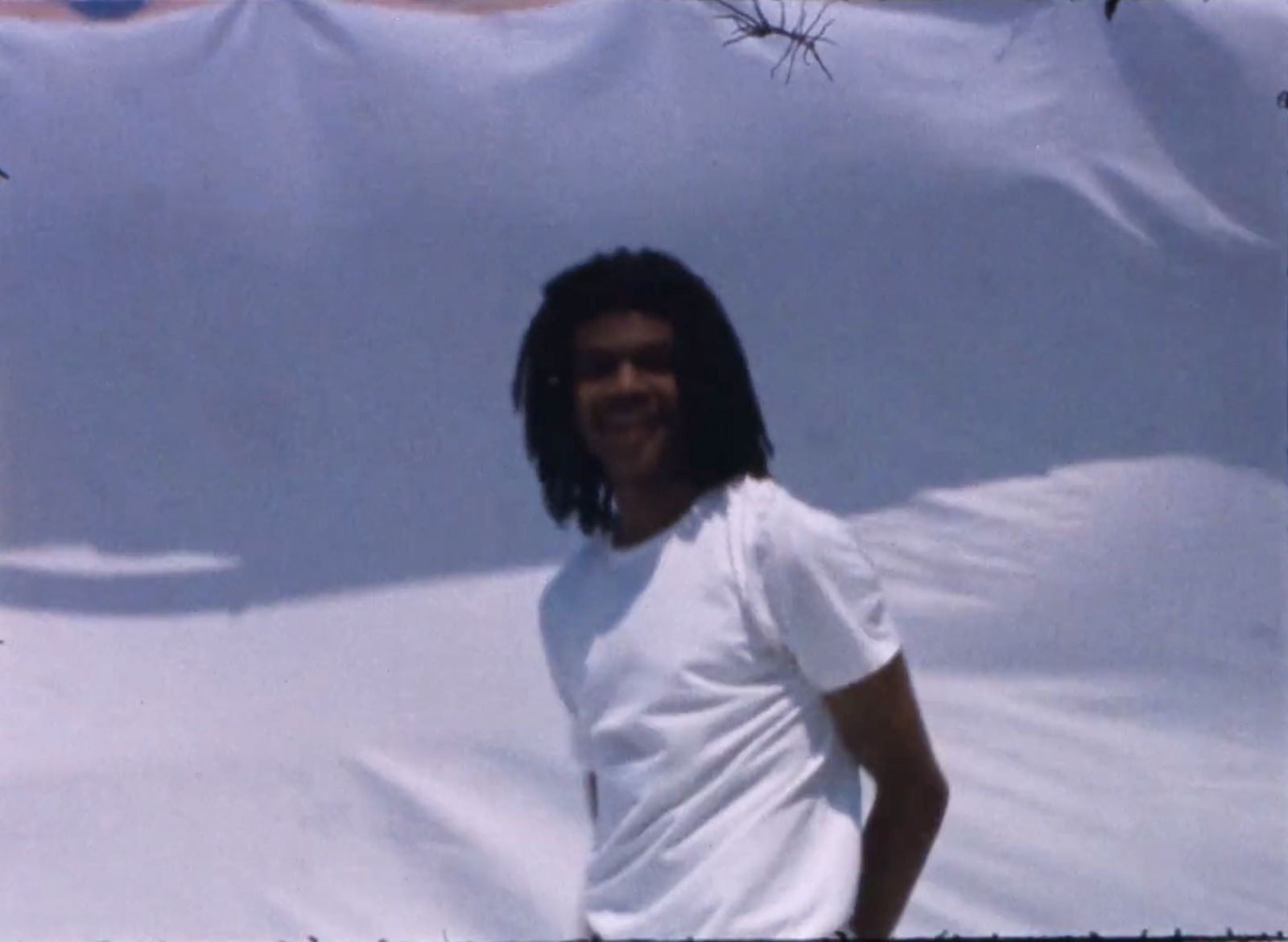 a man standing in front of a white wall