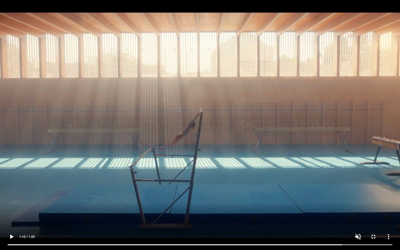 a tennis court with sun shining through the windows