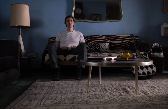 a man sitting on a couch in a living room