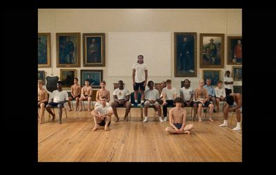 a group of young men sitting on top of a hard wood floor