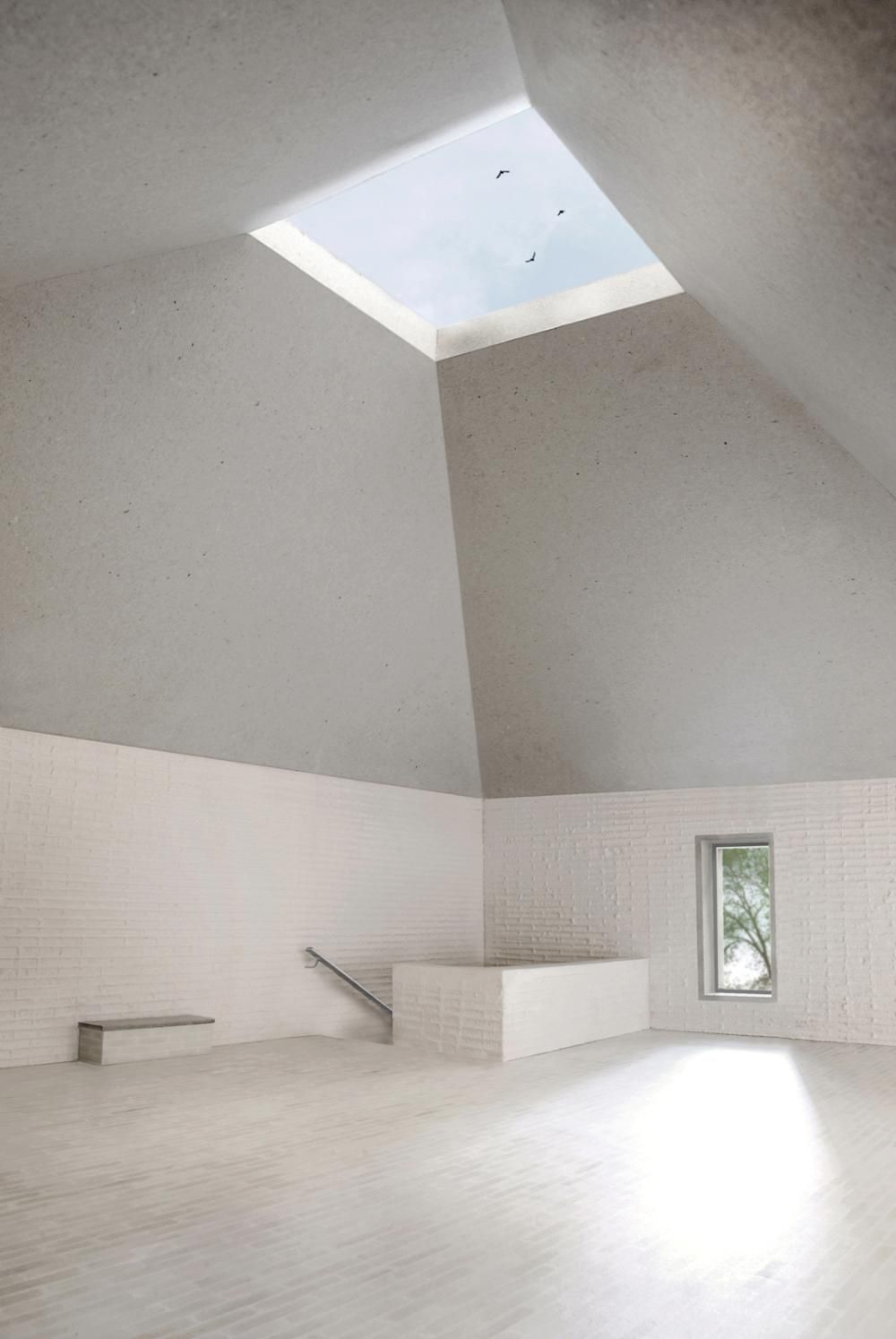 an empty room with a skylight above it