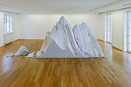 a large room with a mountain sculpture in the middle of it