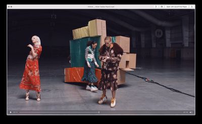 a group of women standing next to each other in front of boxes