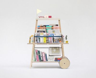 a bookshelf with books and magazines on it