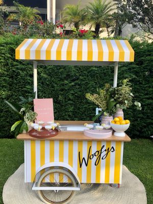 a yellow and white striped ice cream cart