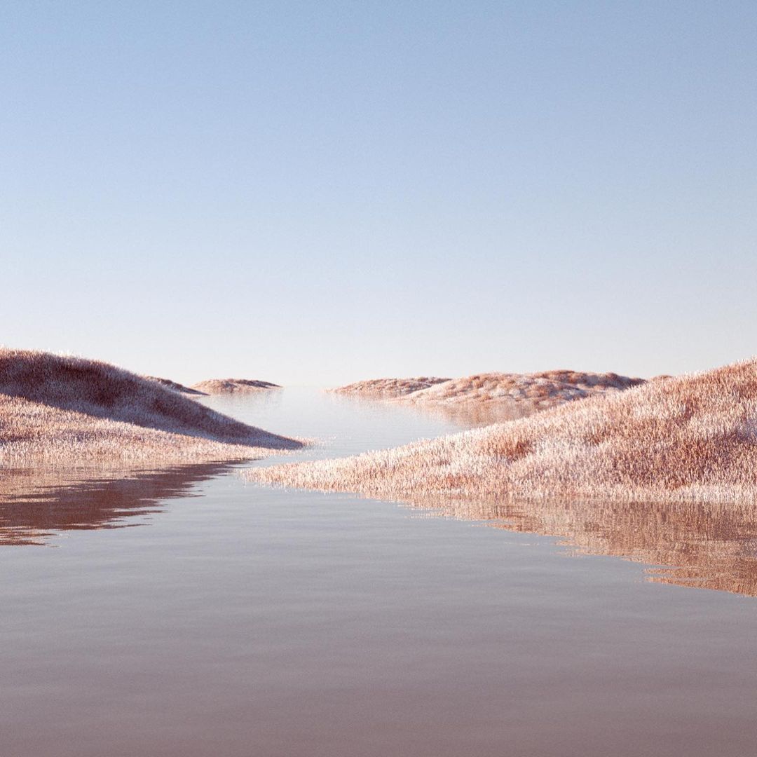 a body of water surrounded by snow covered hills