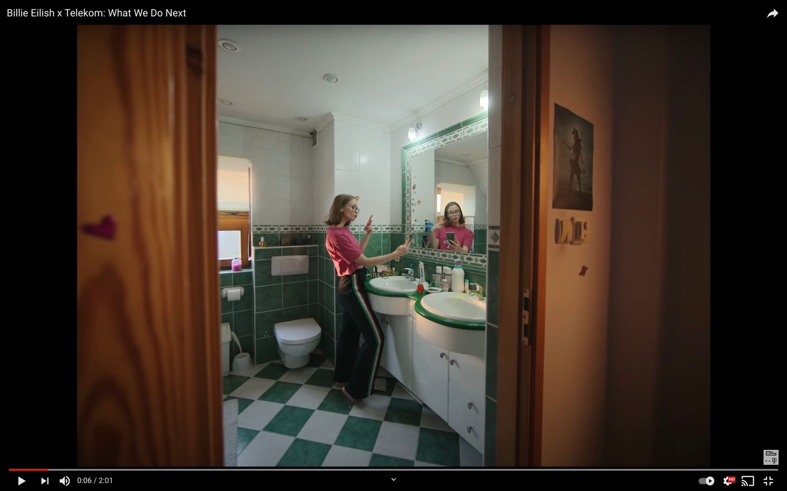 a woman standing in front of a mirror in a bathroom