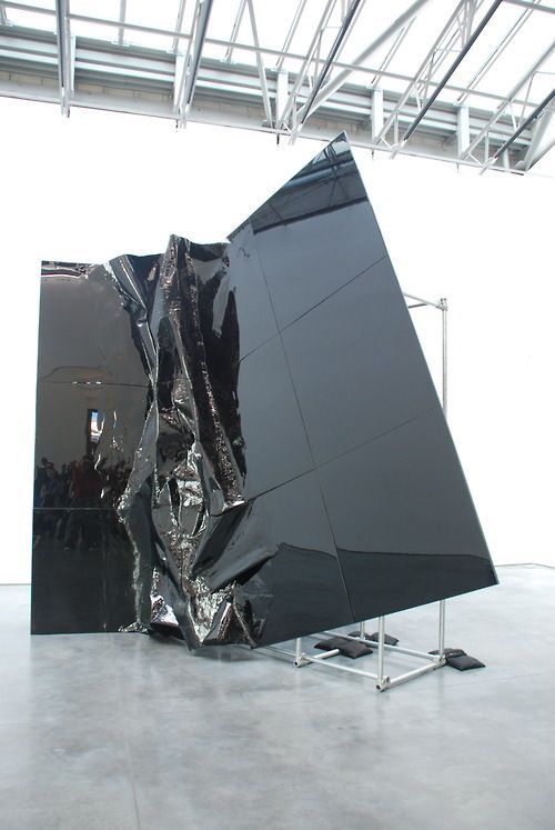 a large black object sitting on top of a metal stand