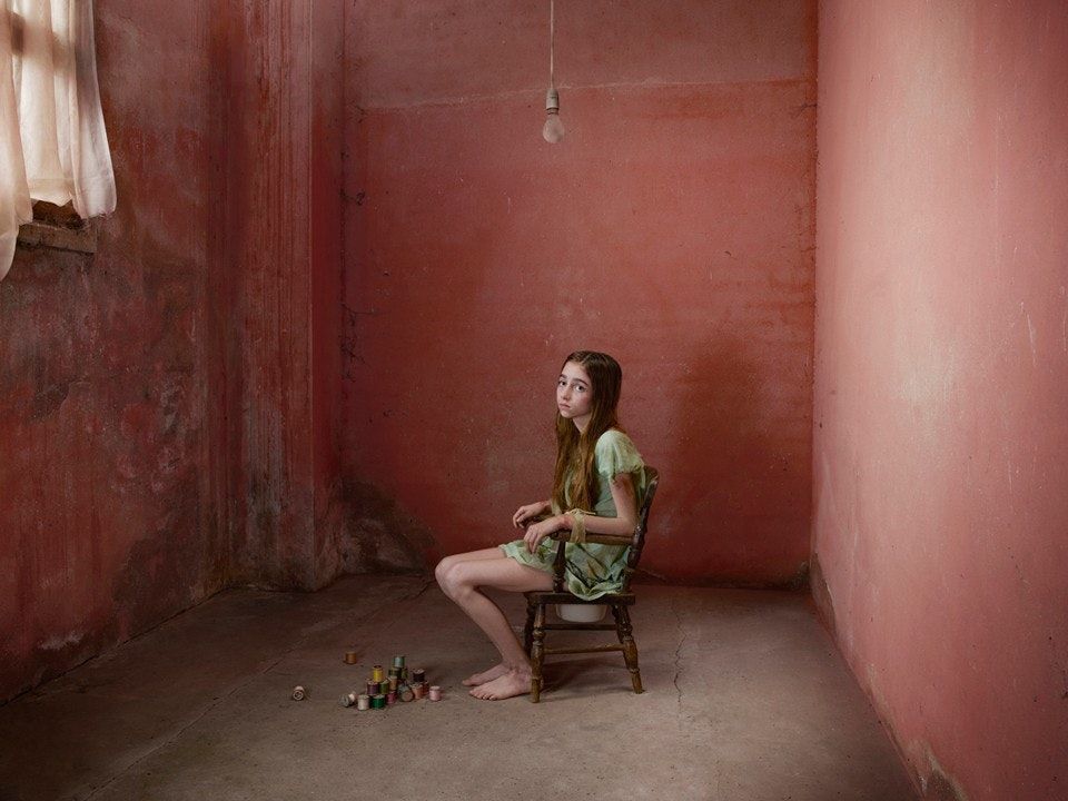 a woman sitting on a chair in a room