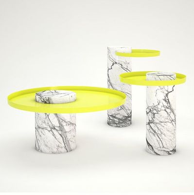 a marbled table with three yellow trays