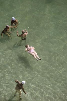 a group of people swimming in a body of water