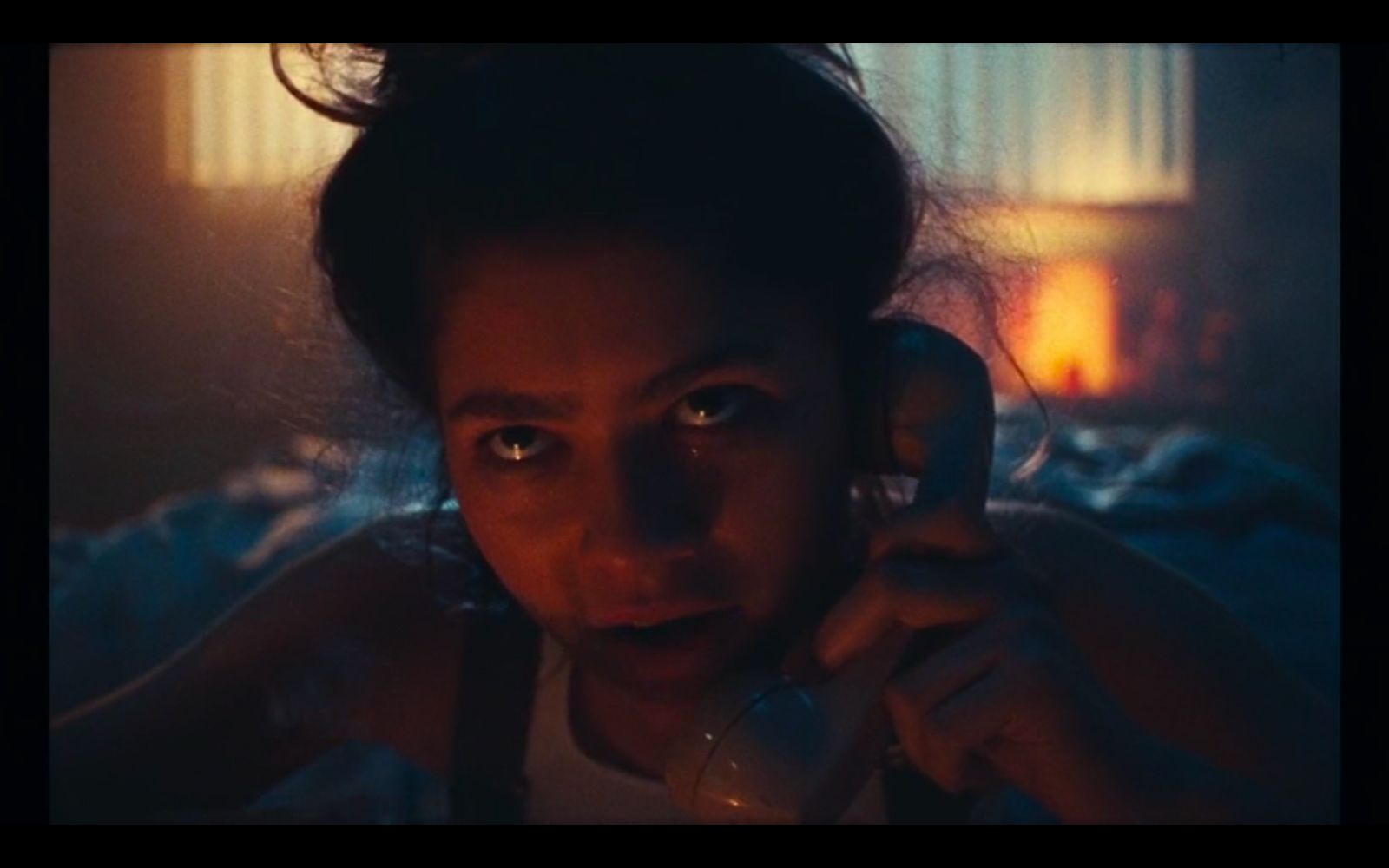 a woman talking on a cell phone in a dark room