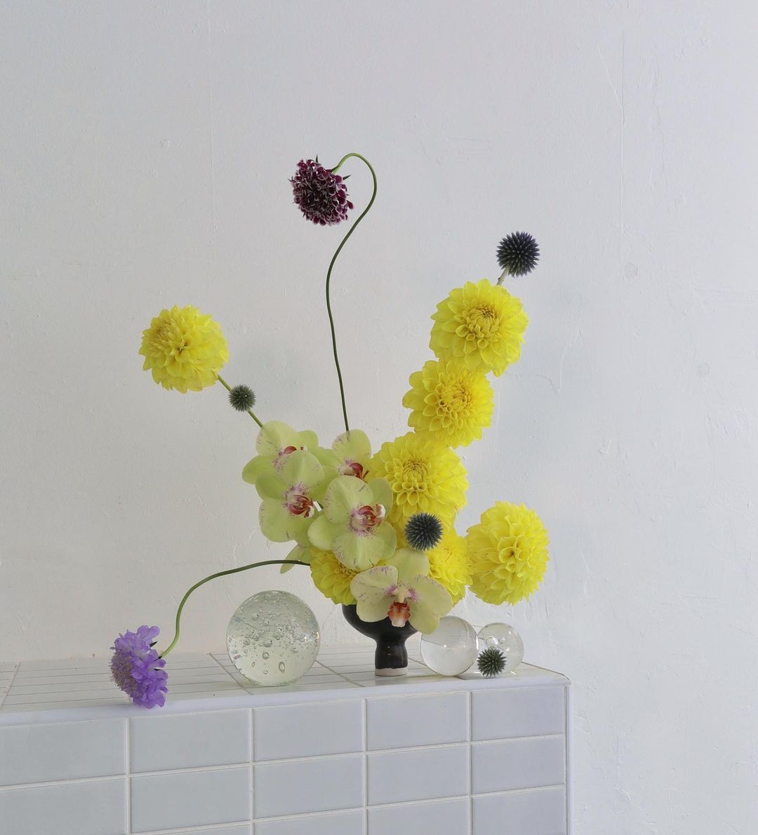 a vase filled with yellow and purple flowers