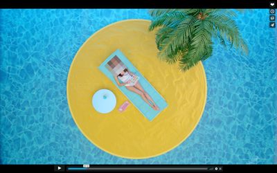 a woman laying on top of a blue and yellow pool