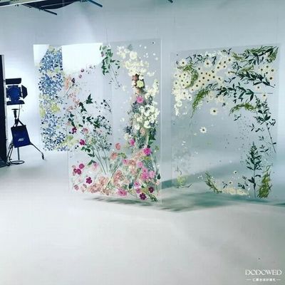 a white room with three floral paintings on the wall