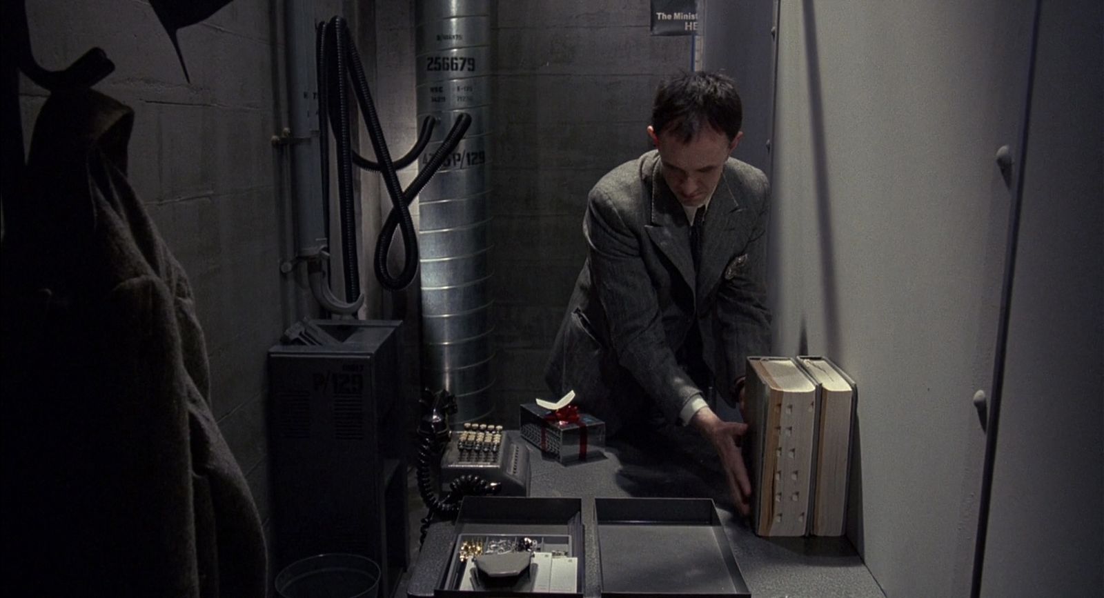 a man kneeling down in a room with a suitcase