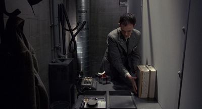 a man kneeling down in a room with a suitcase