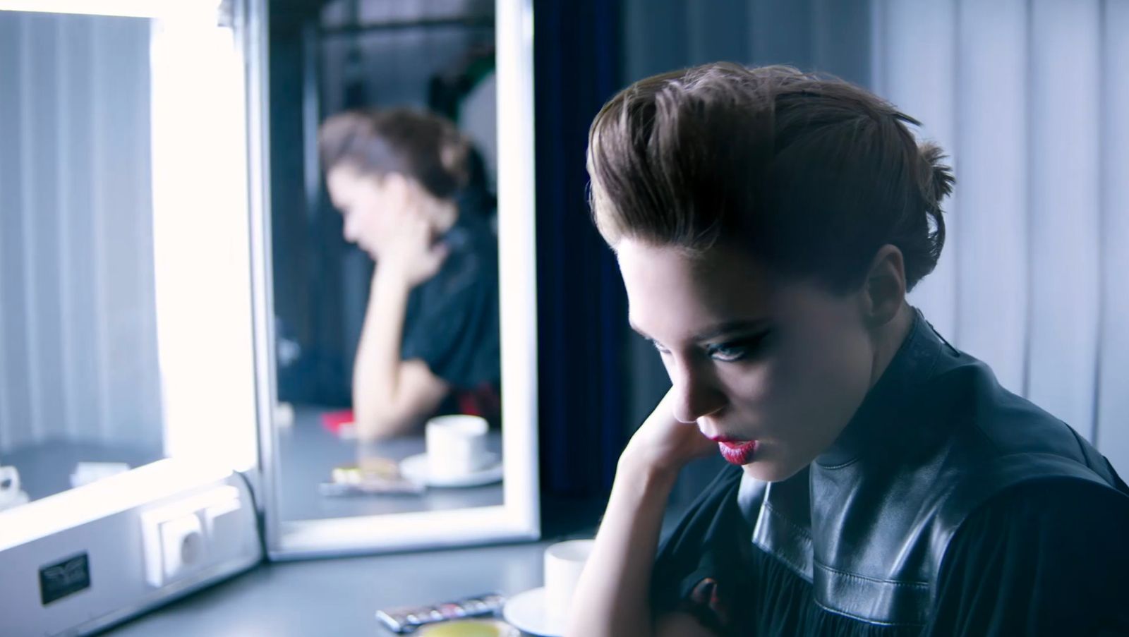 a woman looking at her reflection in a mirror