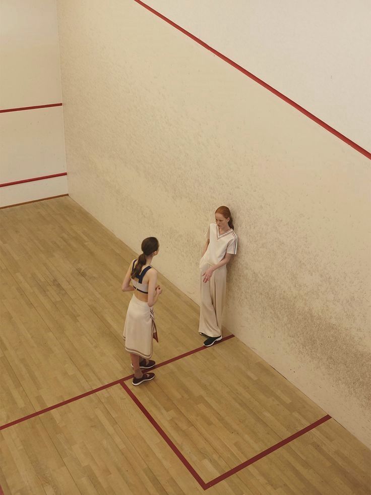 two young girls standing next to each other in a room