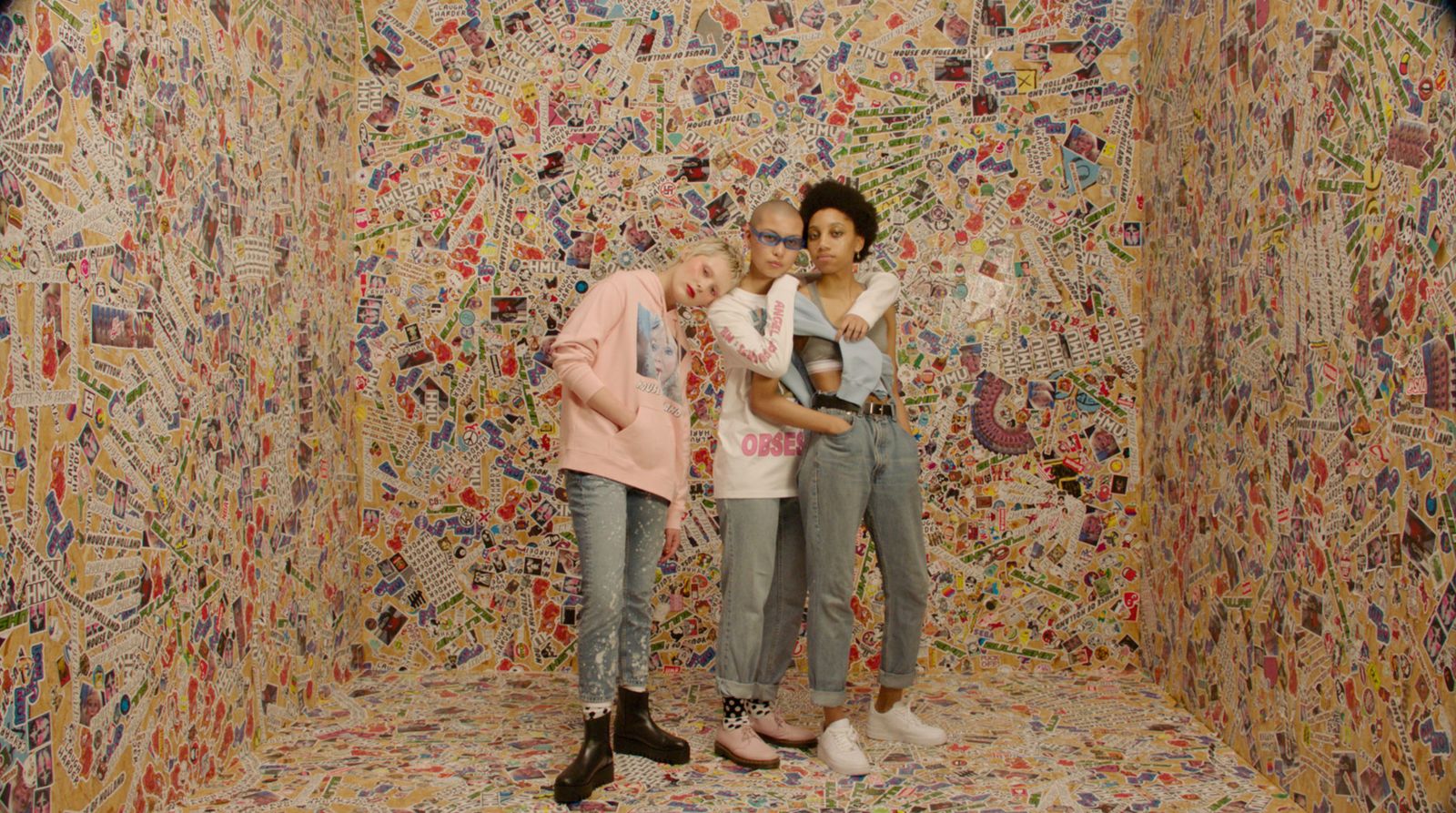 a group of people standing in front of a wall