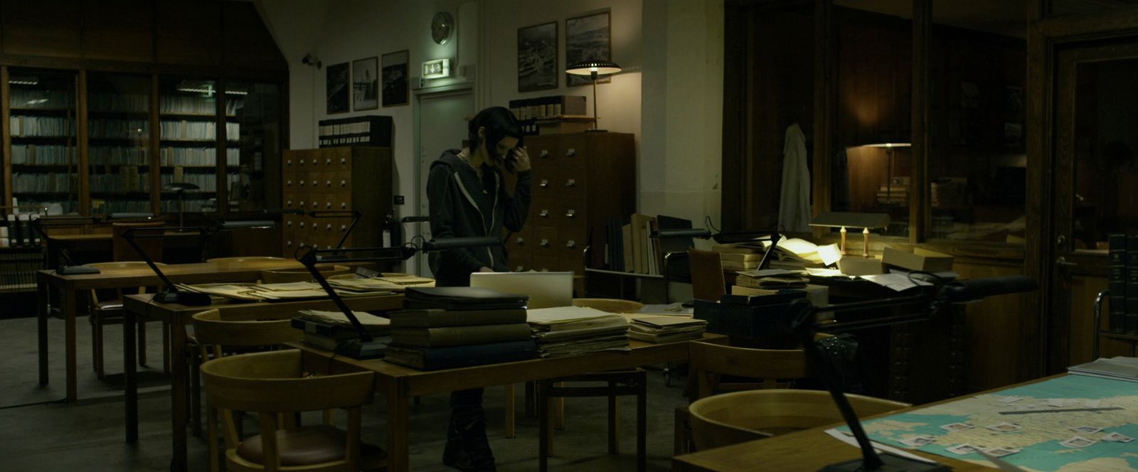 a room filled with lots of books and desks