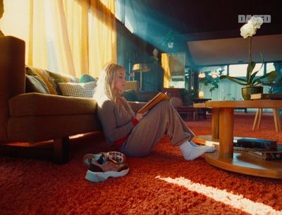 a woman sitting on the floor reading a book